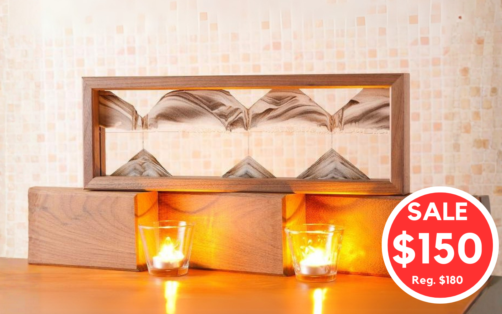 A walnut wood Sand picture called Triple X Walnut sitting on a display shelf  shown lit with warm candlelight on a wooden surface. A red circular sale for $150 reg price $180. 